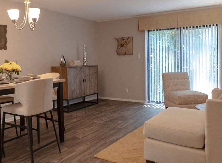 large living room and dining area with sliding glass doors in an apartment in Macon GA